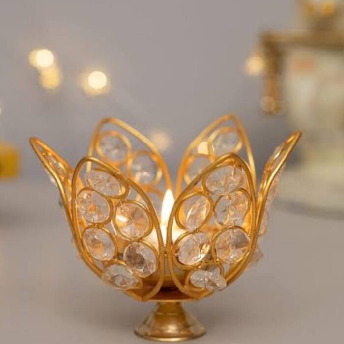 Gold-plated Akhand Diya with crystal embellishments for pooja and home décor.